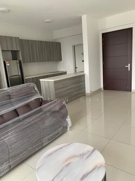 Living features: grey fabric sofa wrapped in plastic, marble coffee table, kitchen island with grey cabinetry, stainless-steel fridge, built-in cabinets, white walls, tile flooring, recessed ceiling lights, door to hallway, open layout; style: modern.