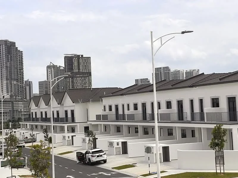 Exterior type: linked terrace house; features: white painted facade, flat roof, 2-storey, balconies on upper level, manicured lawn, paved walkway, street lighting, surrounded by urban skyline, driveway with interlocking pavers; style: modern.