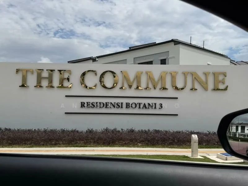 Exterior features: signage with gold lettering, white painted facade, landscaped garden area, manicured lawn, modern architectural design, two-storey building, cloudy sky in background; style: modern.