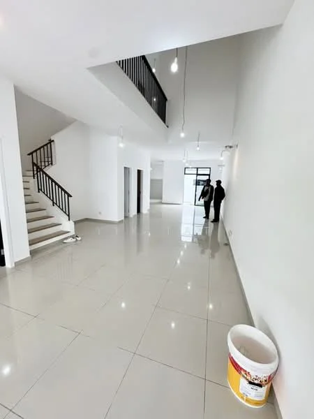 Room features: white painted walls, glossy ceramic tile flooring, staircase with wooden handrail, recessed downlights, large windows for natural light, open space layout, high ceiling, bucket on the floor; style: modern.