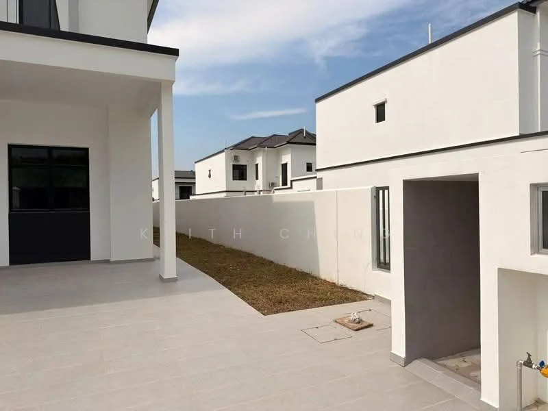 Exterior type: detached bungalow; features: white painted facade, flat roof, two-storey structure, manicured lawn area, paved outdoor patio, side garden, multiple windows, concrete wall, visible neighboring houses; style: modern.
