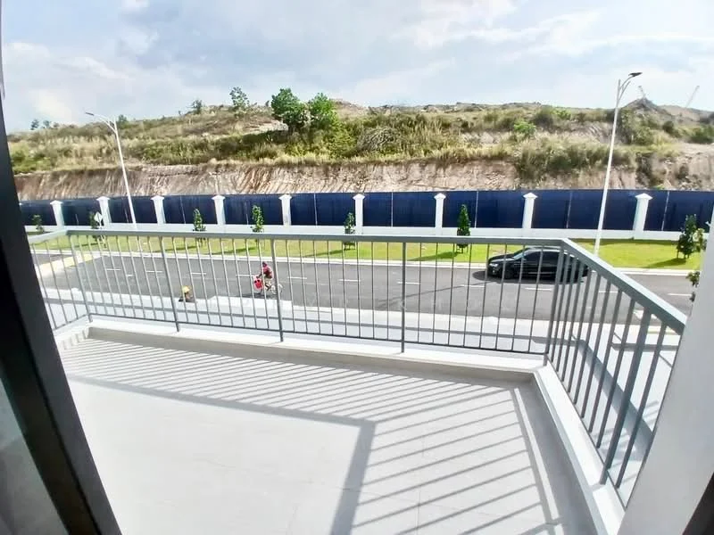 Room features: balcony, metal railing, concrete flooring, street view, surrounding greenery, partial wall, sunlight casting shadows, open space; style: modern; view: street.