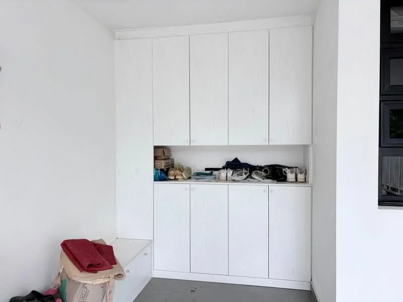 Room features: white cabinetry, built-in storage cabinets, countertop, grey flooring, shelves with various items, shoes on display, blank wall, natural light from window; style: modern.
