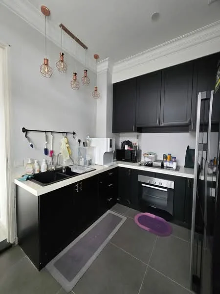 Kitchen features: black cabinetry, white countertop, stainless-steel sink, chrome pull-down faucet, built-in oven, freestanding coffee machine, microwave, refrigerator, 3 pendant lights, grey tile flooring, wall-mounted shelving, kitchen mat; style: modern.