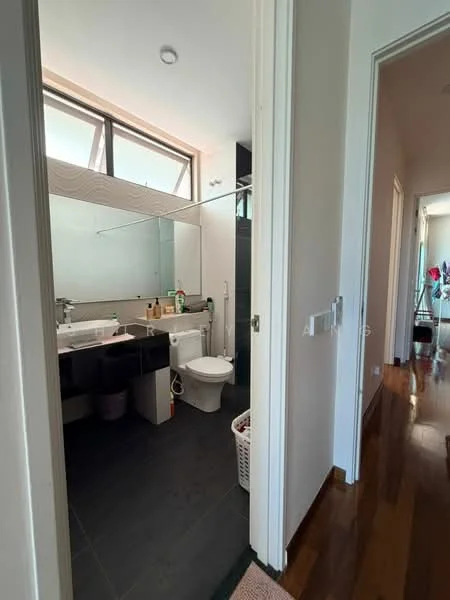 Bathroom features: single-sink vanity with black cabinet, mirror above vanity, toilet, walk-in shower with glass enclosure, chrome basin mixer faucet, grey tile flooring, white walls, window for natural light, laundry basket, shower shelf, towel rack; style: modern. Hallway features: wooden flooring, white walls, doorway leading to another room, light fixture.