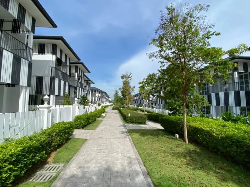 Exterior type: linked terrace house; features: manicured lawn, tropical landscaping, paved walkway, two-storey buildings, balconies with railings, green hedges, trees lining the pathway, white picket fence, clear blue sky; style: modern.