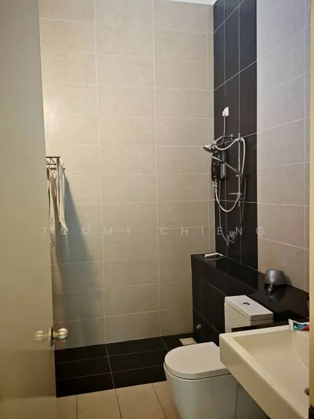 Bathroom features: grey tiled walls, black tiled accent wall, white sink with countertop, single-sink vanity, chrome basin mixer faucet, white one-piece toilet, shower with wall-mounted showerhead, towel rack, mirror, dark cabinetry under sink; style: modern.