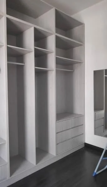 Room features: built-in wardrobe with open shelving, light wood cabinetry, drawers at the bottom, mirror on the wall, dark wood flooring; style: modern.