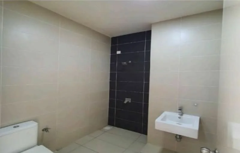 Bathroom features: white wall tiles, dark accent wall tiles, floor tiles, wall-mounted sink, toilet, shower area, chrome faucet, shower head; style: modern.