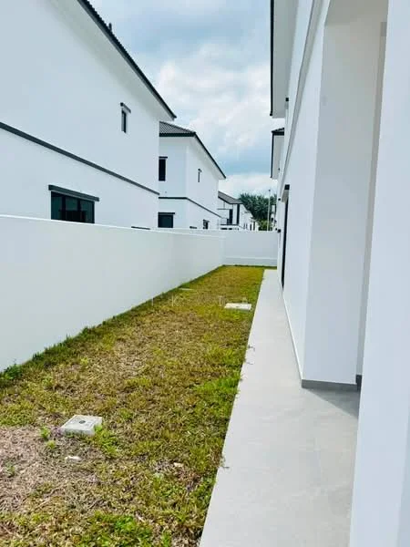 Exterior features: white painted facade, grass lawn, paved walkway, surrounding walls, two-storey buildings, clear sky; style: modern.
