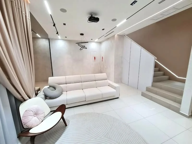 Living features: white leather sofa, round area rug with geometric pattern, white tiled flooring, recessed downlights, wall-mounted projector, curtains in light beige, accent wall with textured finish, staircase with light-colored steps, decorative wall art, modern armchair with wooden legs, cushion on armchair; style: modern.