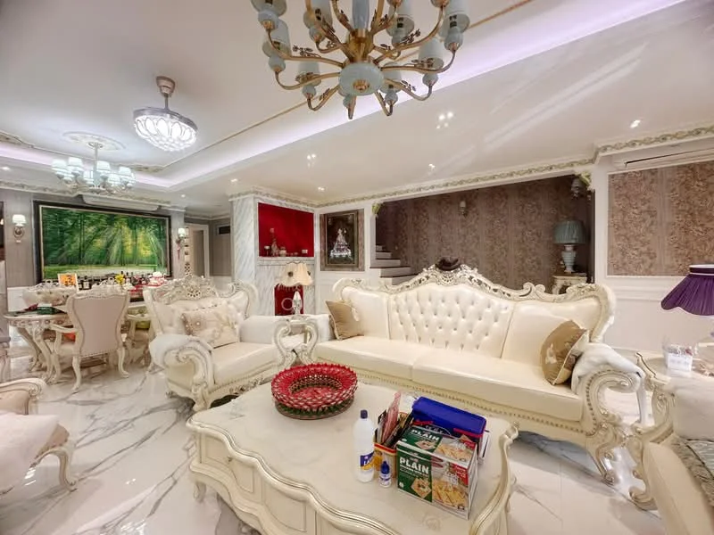 Living features: white tufted leather sofa, ornate coffee table, chandelier with multiple bulbs, recessed ceiling lights, decorative wall paneling, marble flooring, large window with garden view, wall-mounted artwork, decorative vases, cream-colored armchairs, elegant side table, plush area rug; style: luxury; view: garden.