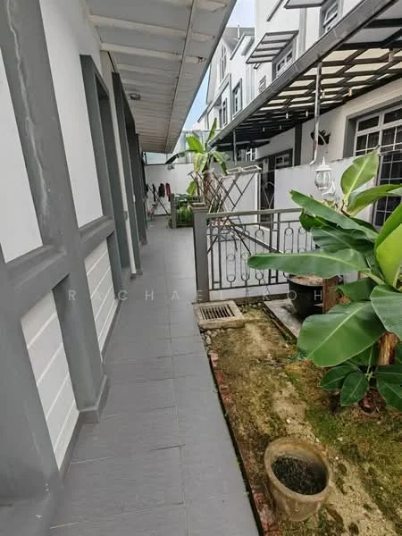 Exterior type: linked terrace house; features: grey painted facade, paved walkway, fenced garden area, potted plants, banana plants, drainage grate, overhead awning, outdoor lighting, side entrance, manicured landscaping; style: modern.