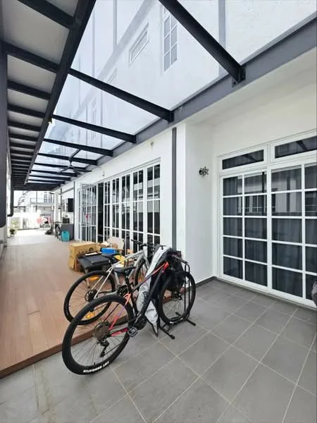 Room features: grey tiled flooring, white painted walls, large glass windows, metal roof structure, wooden decking, bicycles, outdoor furniture, exposed beams; style: modern.