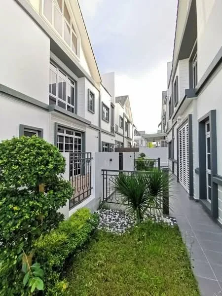 Exterior type: linked terrace house; features: white painted facade, grey trim on windows and doors, manicured lawn, landscaped garden with shrubs, stone-paved walkway, fenced garden area, multiple storeys, balconies on upper levels; style: modern.