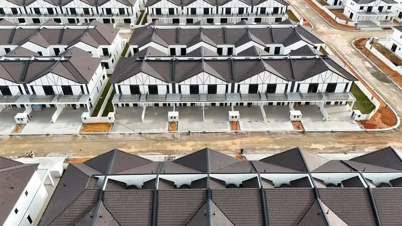 Exterior type: linked terrace house; features: white painted facade, pitched tile roof, multiple storeys, driveway with interlocking pavers, manicured lawn, surrounded by mature greenery, fronts a quiet residential street; style: modern.