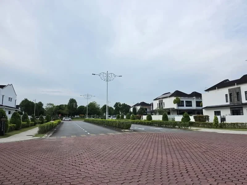 Exterior type: linked terrace house; features: paved road with interlocking bricks, street lamps with decorative design, manicured hedges along the road, white painted fences, two-storey houses, gated community entrance, landscaped gardens in front of houses, asphalt road, surrounded by greenery; style: modern.