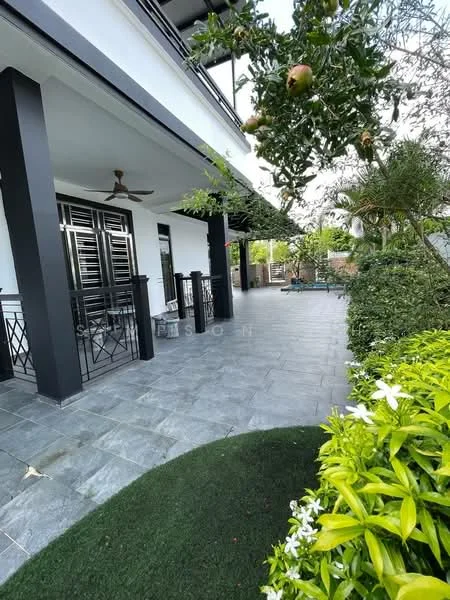 Exterior type: detached bungalow; features: stone-paved walkway, manicured lawn, tropical landscaping, covered porch, black metal railings, ceiling fan on porch, lush greenery, garden area with flowers, outdoor seating area, fenced perimeter; style: modern.