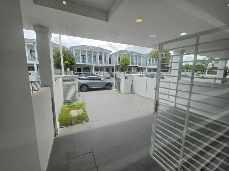 Exterior type: linked terrace house; features: white painted facade, flat roof, driveway with interlocking pavers, manicured lawn, surrounded by mature greenery, car porch, security gate, visible street view; style: modern.