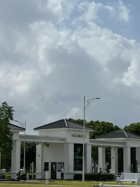 Exterior type: main entrance gate; features: white painted facade, flat roof with tiles, large entrance columns, glass doors, landscaped greenery, paved walkway, street lighting, signage with 'MILLWOOD', surrounding trees; style: modern.