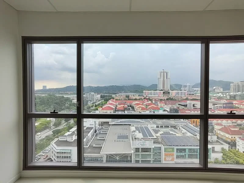 Room features: large floor-to-ceiling windows, city skyline view, mountain view, grey clouds in the sky, urban landscape, commercial buildings visible, residential buildings visible, green hills in the background; style: modern; view: city.