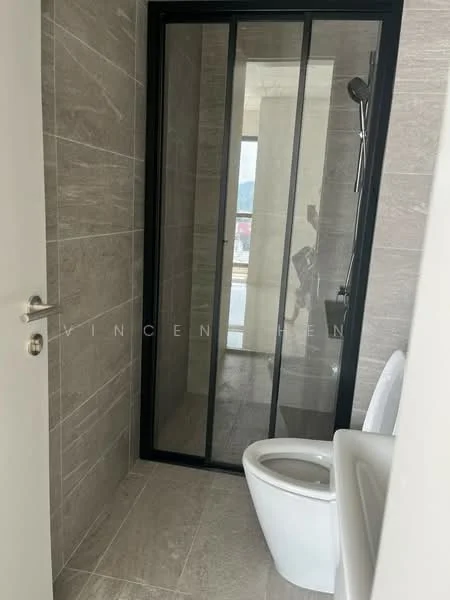 Bathroom features: glass shower enclosure, rain shower head, handheld shower, white toilet, grey tile flooring, grey wall tiles, black framed shower door, modern faucet, sink with countertop; style: modern.