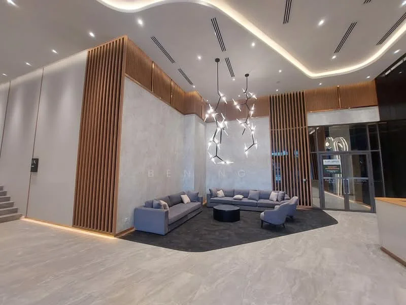 Lobby features: modern chandelier, grey fabric sofas, black circular coffee table, textured wall panels, marble flooring, recessed lighting, wooden accent wall, large glass entrance, decorative wall art; style: modern.
