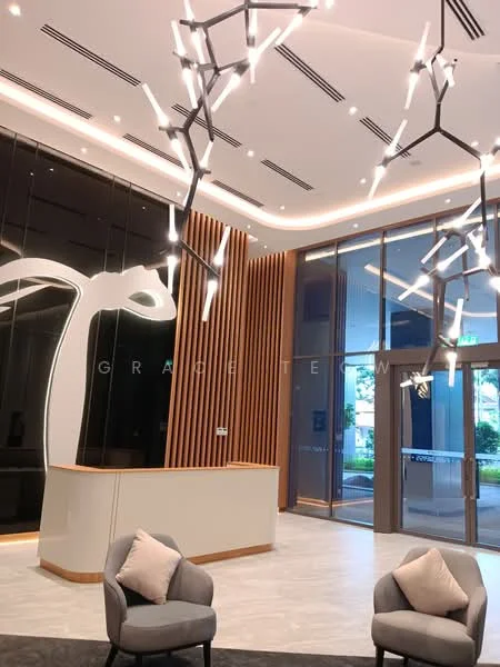 Room features: modern reception desk, decorative wall with abstract design, wood paneling on wall, large glass windows, recessed ceiling lights, unique chandelier lighting, grey upholstered chairs, marble flooring, greenery visible outside, open layout, neutral color palette; style: modern; view: garden.