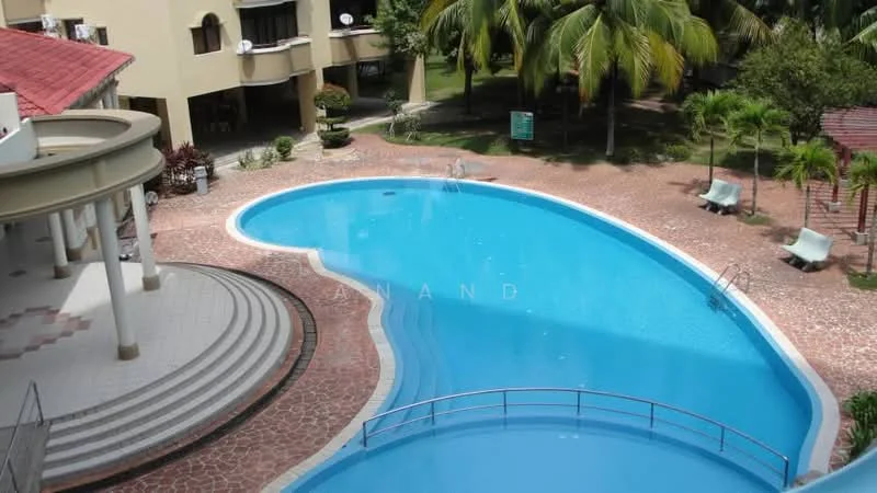 Exterior type: low-rise apartment block; features: curved swimming pool, pool deck with loungers, manicured landscaping, palm trees, stone-paved walkway, covered pavilion, steps leading to pool, balconies visible on building, green lawn area; style: modern.