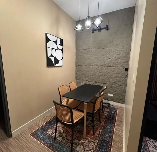 Dining features: black rectangular dining table, 4 rattan dining chairs, decorative area rug with geometric pattern, stone accent wall, pendant lighting with multiple bulbs, wall-mounted light fixture, cream painted walls, laminate flooring; style: modern.