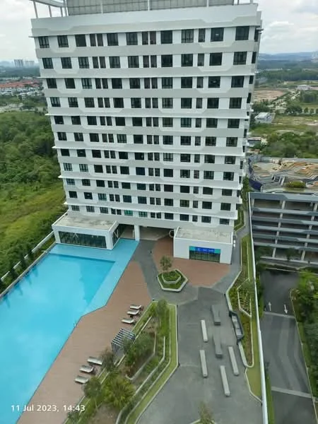 Exterior type: high-rise condominium; features: infinity pool, pool deck with loungers, landscaped garden area, paved walkway, multi-storey car park, surrounded by greenery; style: modern.