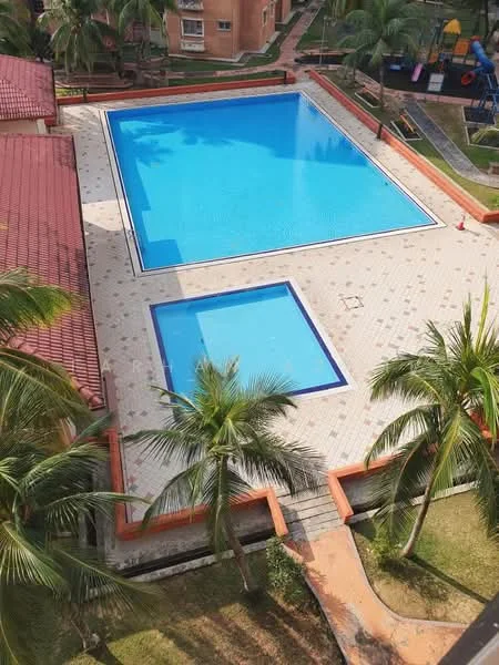Exterior type: swimming pool deck; features: large rectangular swimming pool, smaller square children's pool, surrounding tiled deck, palm trees, manicured lawn, playground equipment visible in background, landscaped garden area, poolside loungers, safety cones near pool edge; style: modern.