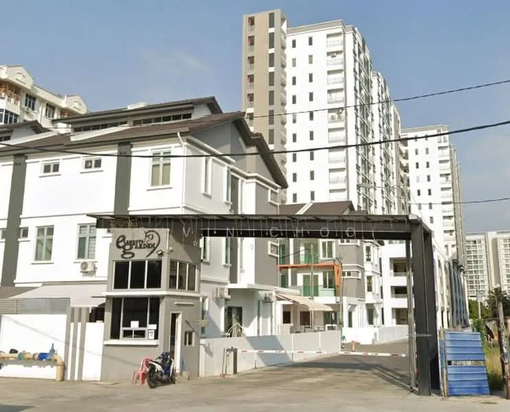 Exterior type: linked terrace house; features: white painted facade, flat roof, 2-storey building, manicured lawn, paved driveway, security gate, surrounded by mature greenery, adjacent to high-rise buildings; style: modern.
