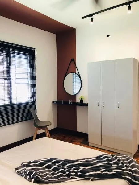 Bedroom features: brown accent wall, white painted walls, wooden flooring, floor-to-ceiling window with black blinds, round mirror, grey wardrobe with two doors, black wall shelf, chair with wooden legs, bed with white bedding, recessed ceiling lights; style: modern.
