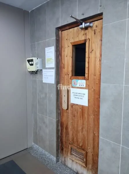 Room features: wooden door, grey tiled walls, granite flooring, signage on wall, electrical panel, wood paneling on door, metal handle, notice board; style: modern.
