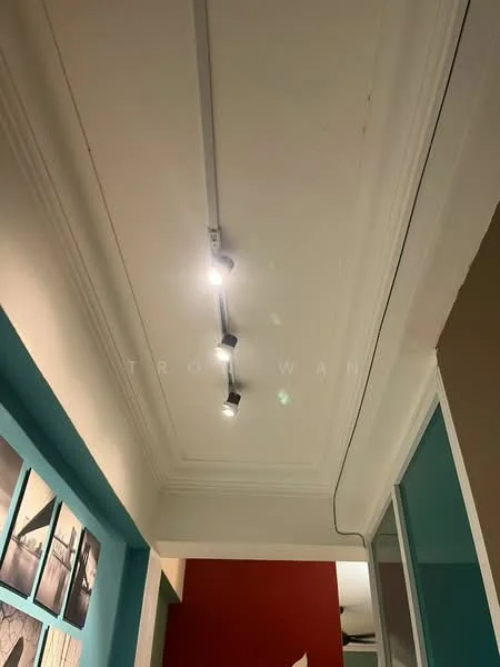 Room features: recessed ceiling, track lighting with multiple spotlights, white painted ceiling, crown moulding, wall with framed artwork, painted wall in beige, painted wall in teal; style: modern.