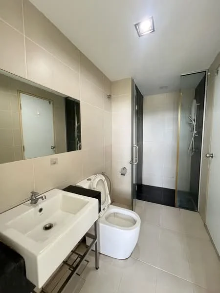 Bathroom features: single-sink vanity with chrome faucet, framed mirror above sink, toilet, walk-in shower with glass enclosure, rain shower head, tile cladding on walls, ceramic tile flooring, recessed downlights; style: modern.