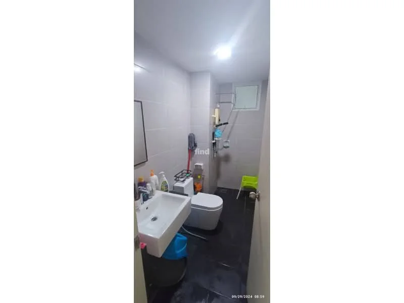 Bathroom features: white tiled walls, black tile flooring, single-sink vanity with white cabinet, chrome basin mixer faucet, one-piece toilet, shower with glass partition, mirror above sink, toiletries on countertop, small green chair, window for natural light; style: modern.