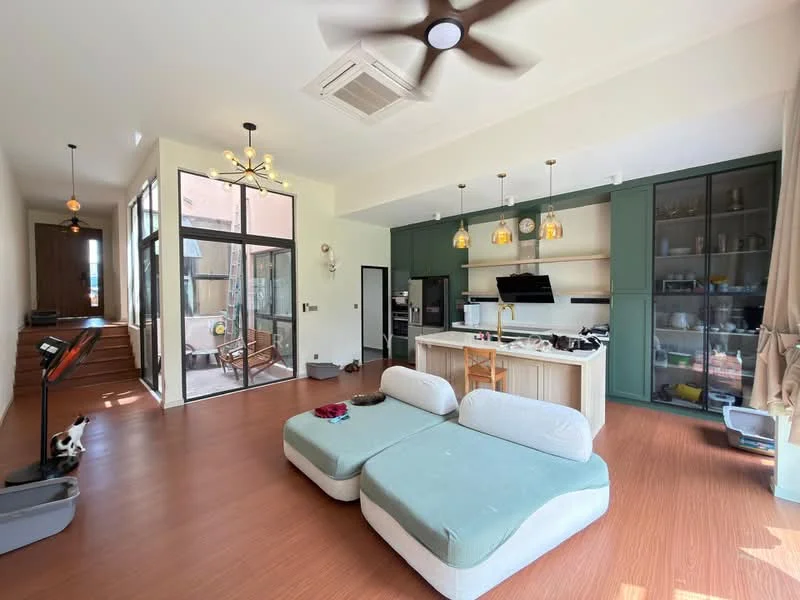 Living features: L-shape sectional sofa in light blue, wooden flooring, 5-blade ceiling fan with light, recessed downlights, large glass sliding doors, open-plan layout, kitchen island with bar seating, stainless-steel refrigerator, built-in oven, microwave, kitchen cabinetry in green, decorative pendant lights, wall-mounted TV, area rug, decorative plants; style: modern; view: garden.