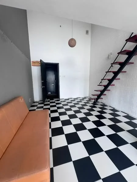 Room features: black and white checkered flooring, orange leather sofa, white painted walls, grey accent wall, black staircase with wooden steps, pendant light fixture, door with black finish, wall-mounted light fixture; style: modern.