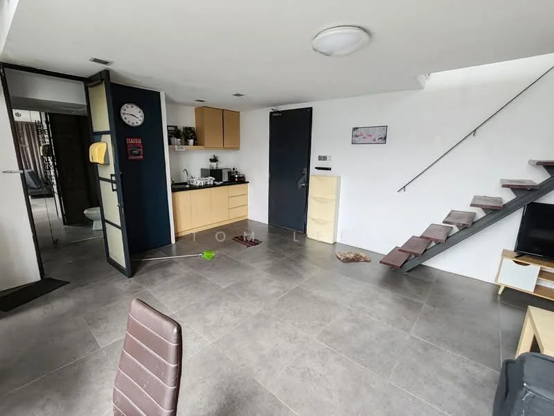 Living features: grey tile flooring, white painted walls, ceiling light fixture, staircase with wooden steps, black door, kitchenette with yellow cabinets, sink, countertop, wall-mounted clock, TV console, open layout, window with view to outdoor space; style: modern. Room features: grey tile flooring, white painted walls, black door, staircase with wooden steps.