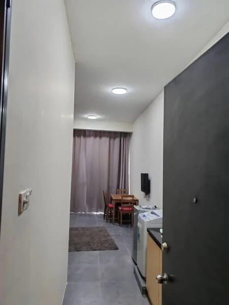 Room features: grey tiled flooring, white painted walls, recessed ceiling lights, curtains in grey, wooden dining table with chairs, wall-mounted TV, washing machine, kitchen cabinetry, rug on floor; style: modern.