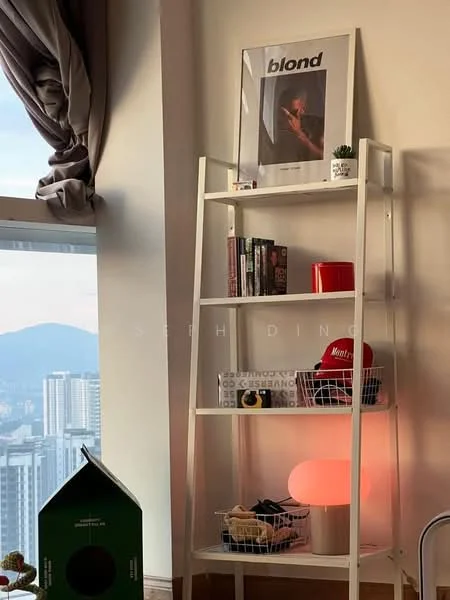 Room features: white shelving unit, decorative framed artwork, books on shelf, red decorative items, basket storage, orange lamp, curtains, city view through window; style: modern; view: city.