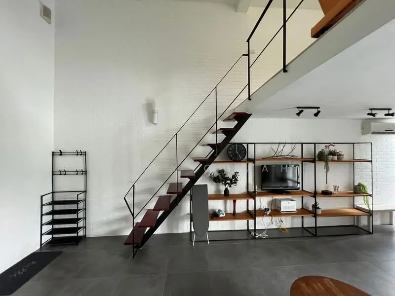 Living features: white painted walls, exposed brick wall, grey tile flooring, metal staircase with wooden steps, open shelving unit, wall-mounted TV, decorative wall clock, air conditioning unit, floor mat at entrance, black metal railing, wooden coffee table; style: modern.