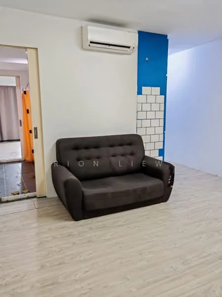 Living features: dark grey fabric sofa, light wood laminate flooring, white painted walls, blue accent wall, exposed brick backsplash, wall-mounted split AC, open doorway leading to another room; style: modern.