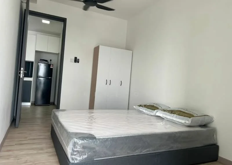 Bedroom features: queen-size bed, mattress with protective cover, two pillows, light wood flooring, white painted walls, ceiling fan, built-in wardrobe with two doors, doorway leading to kitchen area, refrigerator visible in background; style: modern.