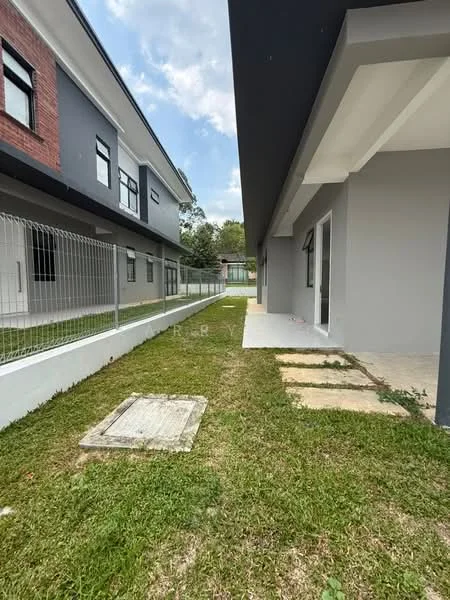 Exterior type: linked terrace house; features: manicured lawn, concrete pathway, fenced perimeter, two-storey building, grey painted facade, brick facade, landscaped garden area, adjacent buildings, clear sky, outdoor space; style: modern.