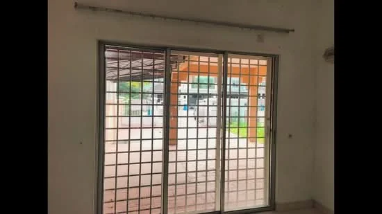 Room features: sliding glass door, grid-patterned window, white painted walls, tile flooring, air conditioning unit, curtain rod, view of outdoor area; view: garden.