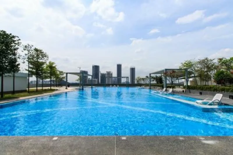 Exterior type: swimming pool deck; features: infinity pool, pool deck with loungers, surrounded by landscaped greenery, city skyline in background, paved walkway around pool, shade structures, trees lining the pool area; style: modern.