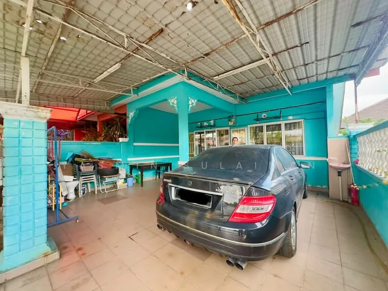 Exterior type: car porch; features: covered car porch, blue painted walls, tiled flooring, metal roof, windows with grills, outdoor seating area, garden area visible, decorative plants; style: modern.